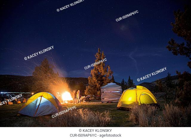 People around campsite fire, Smith Rock State Park, Oregon, US