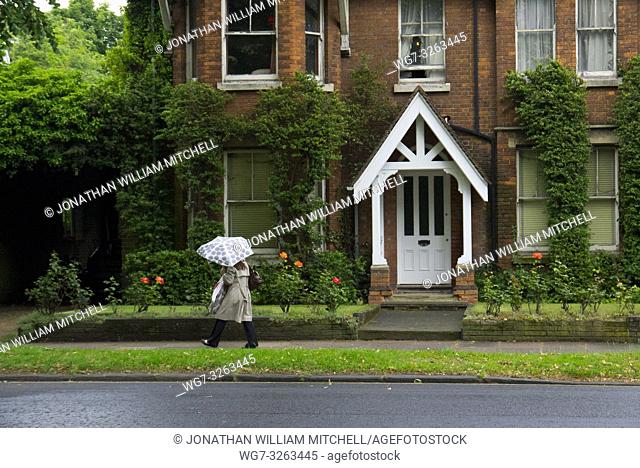 UK Bedford - 21 Jun 2012 - A woman braves rain in Bedford, England, UK. The summer of 2012 has been one of the wettest on record