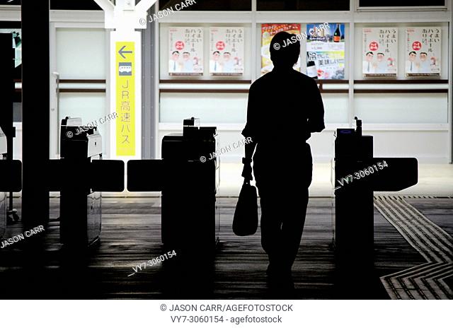 Japanese salaryman going through the exit of the Shinjuku station, Japan