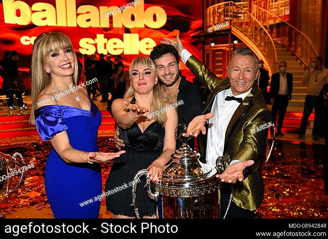 The host Milly Carlucci with the co-host Paolo Belli and the winners Arisa and Vito Coppola during the final of the broadcast Dancing With The Stars
