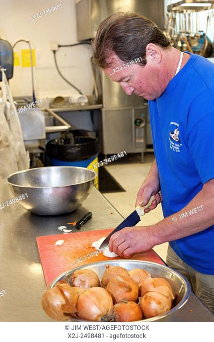 Wellington, Colorado - A resident helps prepare lunch in the kitchen of Harvest Farm, a rehabilitation facility for men recovering from addictions