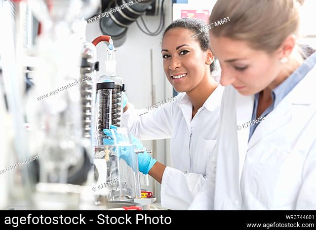 Group of scientists working with gloves and gowns in laboratory