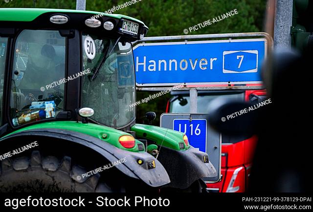 21 December 2023, Lower Saxony, Soltau: Farmers are blocking the access road to highway 7 with their tractors, among other things