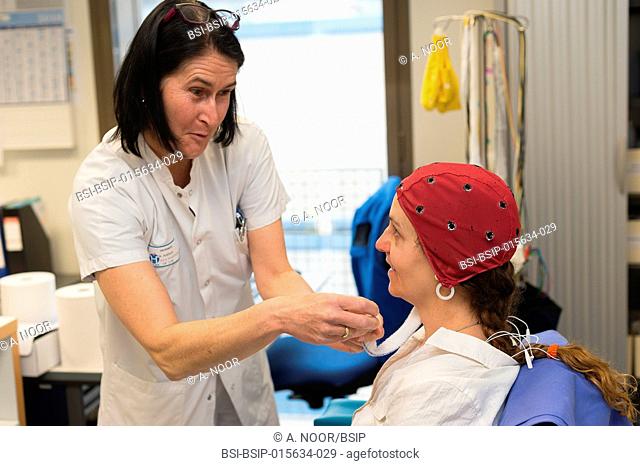 Reportage in the epileptology unit in Nice Hospital, France. Long-term EEG (3 days) for a check-up of partial epilepsy. The nurse uses the headset as a marker