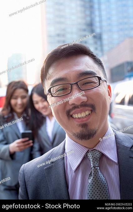 Portrait of smiling businessman outdoors, Beijing