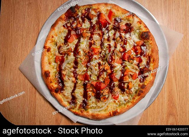 Delicious tomato sauce cheese covered hot and tasty bbq chicken pizza pie