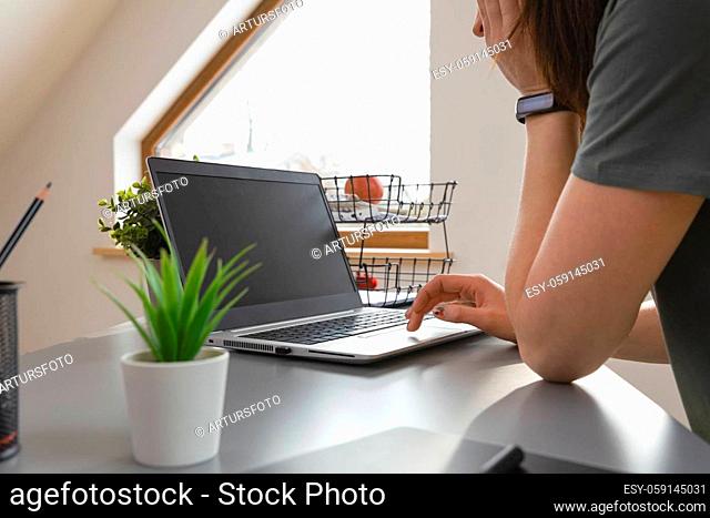 Women browsing in internet by using a mouse pad. Working from home a new normal working concept