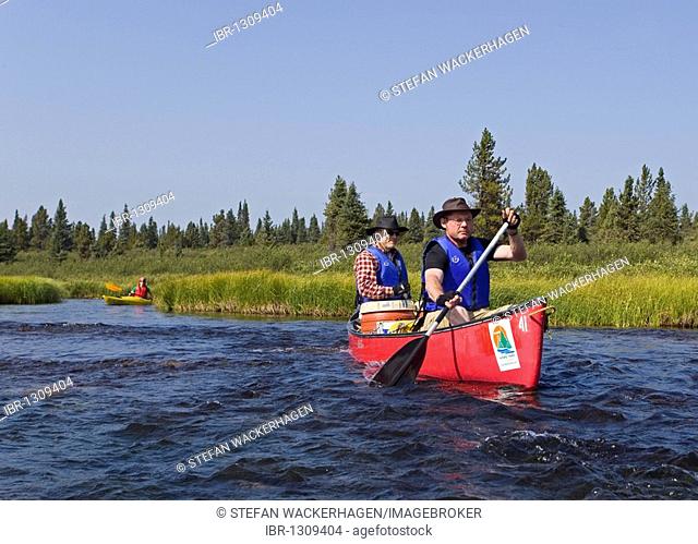 Two men in canoe, paddling, canoeing, Caribou Lakes, Kayak behind, upper Liard River, Yukon Territory, Canada