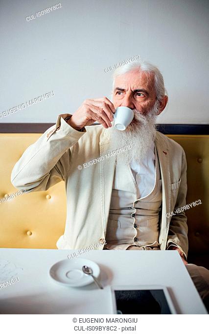 Senior businessman drinking coffee in cafe