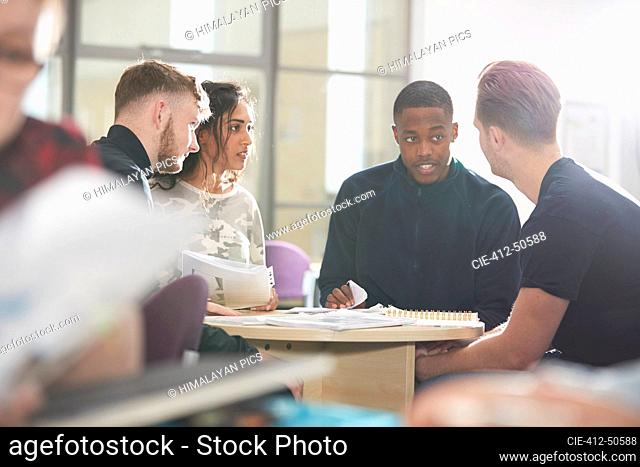 College students talking and studying in classroom