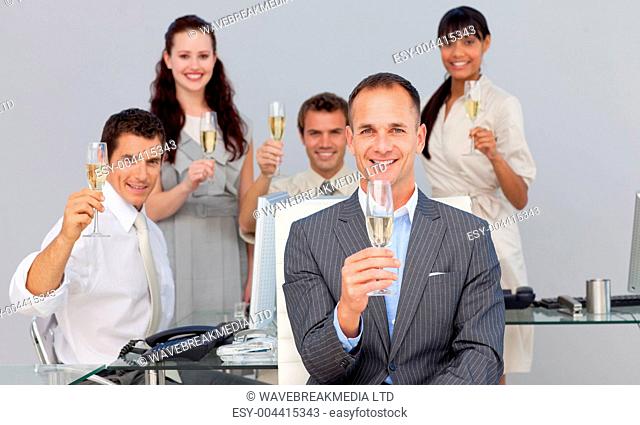 Successful business co-workers toasting with Champagne