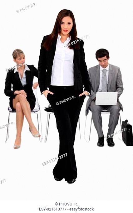 Confident businesswoman waiting with others