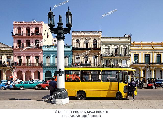 Street with row of houses, candelabra lantern and a yellow bus, Villa San Cristobal de La Habana, old town, La Habana, Havana, UNESCO World Heritage Site
