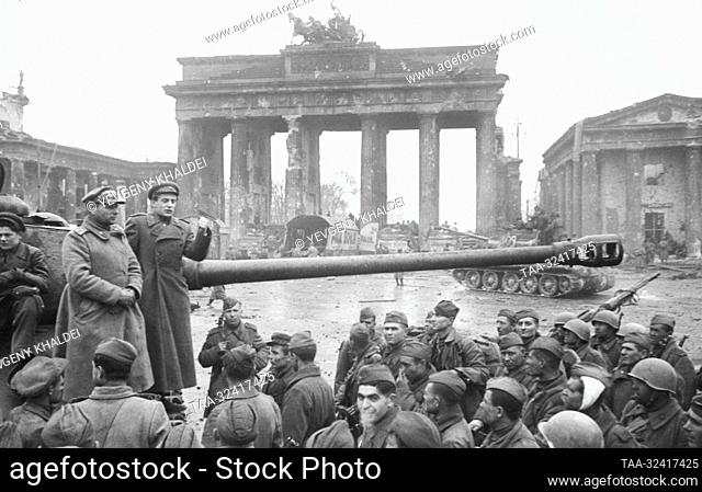 Berlin, Germany. Soviet poet and war correspondent Yevgeny Dolmatovsky (R standing on a tank) gives a speech to Soviet soldiers during a rally at the...