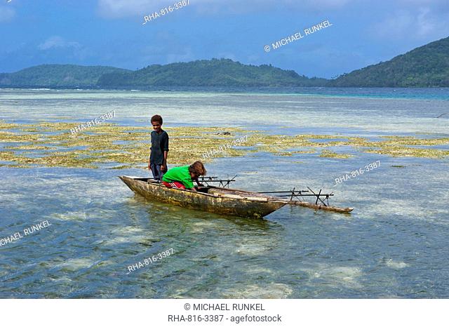 Young boys fishing near Samarai, the old capital, Papua New Guinea, Pacific