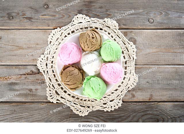 Top view assorted ice cream scoops collection on brown rustic wooden background