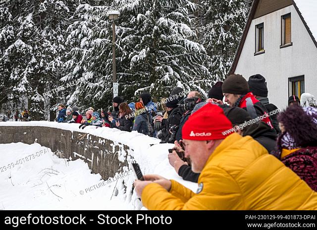 29 January 2023, Thuringia, Oberhof: Numerous people watch the passage of the steam train ""Rodelblitz"" on the line from Eisenach to Arnstadt through the...