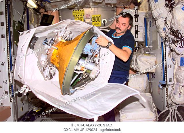 Cosmonaut Mikhail Tyurin, Expedition Three flight engineer, packs the docking probe in a stowage bag in Unity. The docking probe successfully guided the arrival...