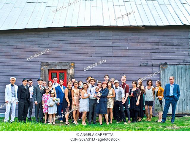 Group portrait of wedding party, outdoors