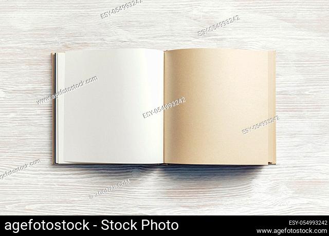 Blank kraft paper booklet on light wooden background. Responsive design mockup. Flat lay