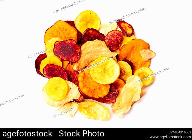 Dry fruit and vegetable chips, healthy vegan snack, a mixed heap on a white background