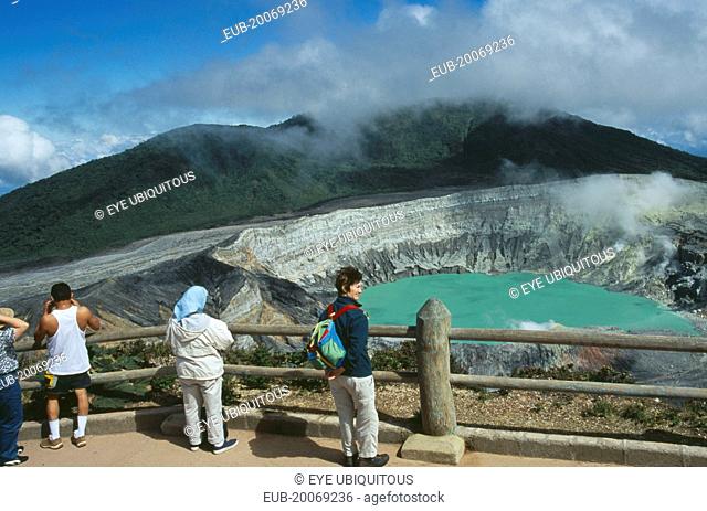 Volcan Poas National Park. View from the observation platform with tourists looking over crater