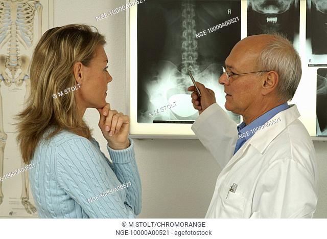a doctor is looking on the backbone of a X-Ray-Image