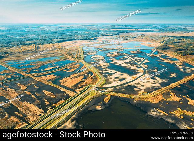Belarus. Aerial View Of Road Through Ponds In Autumn Landscape. Ponds Of Fisheries In The South Of Belarus. Top View Of Fish Farms From High Attitude