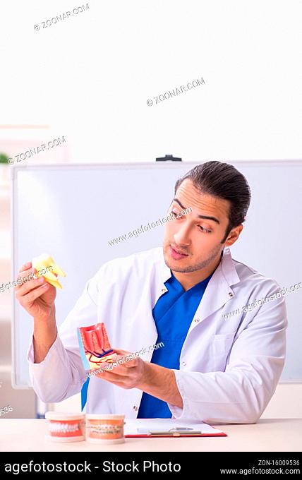 Young male dentist working in the medical clinic