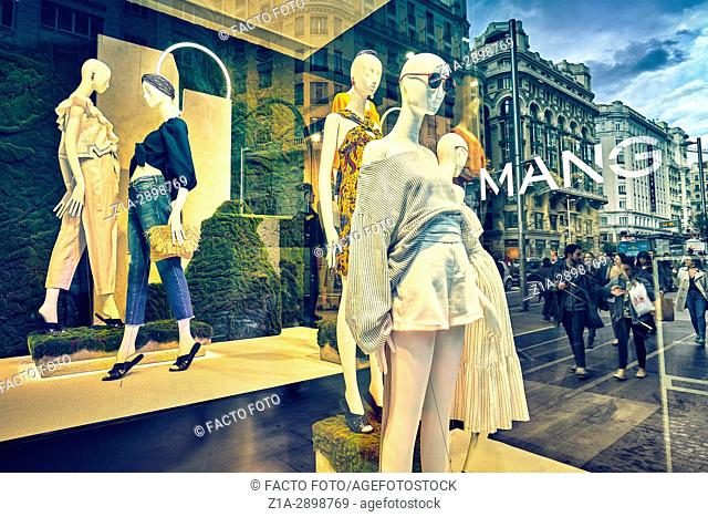 Mannequins and reflections at a window shop in Gran Via avenue. Madrid. Spain