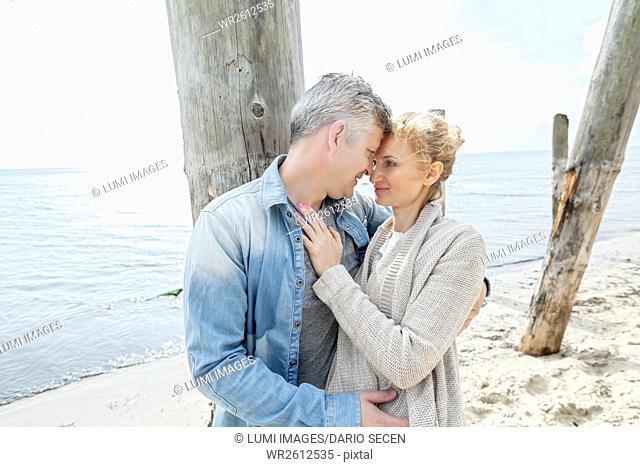 Portrait of couple kissing on beach