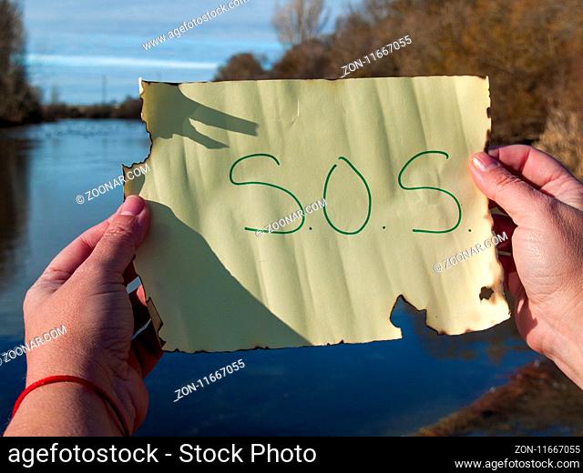 One person reading sos message on a crystal bottle