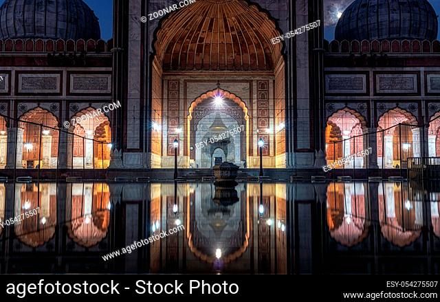 reflections of jama masjid in a small pond in the main courtyard. Taken in New Delhi, India