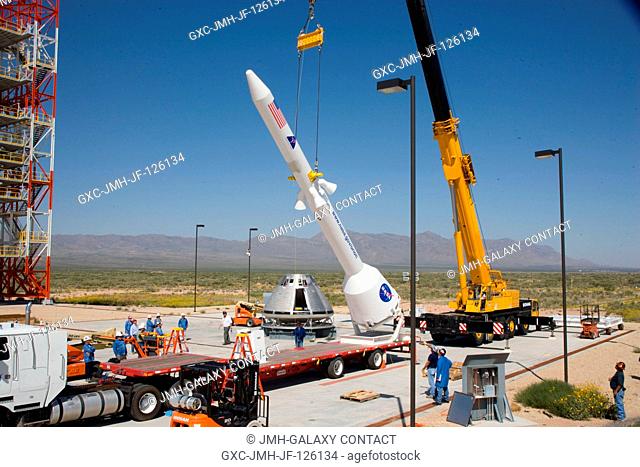 Technicians detach mock-up components, at the U.S. Army's White Sands Missile Range in New Mexico after they practiced the stacking process that will one day be...