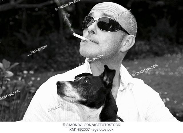 Portrait of man with sunglasses and Jack Russell dog