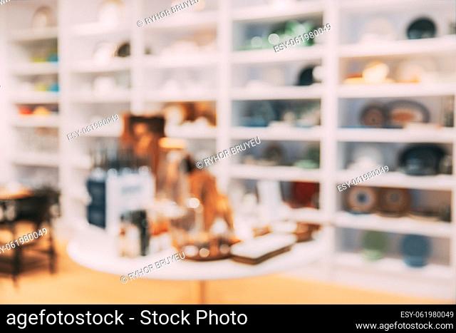 View of assortment of decor for interior shop in store of shopping center. View of shelving with dishes, bowls, plates. View of home accessories for dining room...