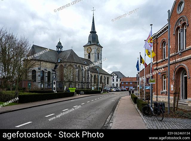 Merchtem, Flemish Brabant Region, Belgium, Feb. 25 2023 - The village center with the catholic church and the city hall