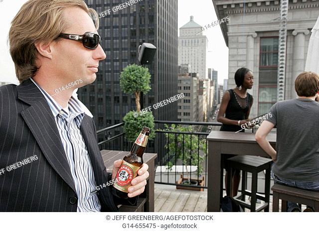 Canada, Montreal, Hotel Place D'Armes, rooftop bar, fashionable man, beer, social hour, city skyline