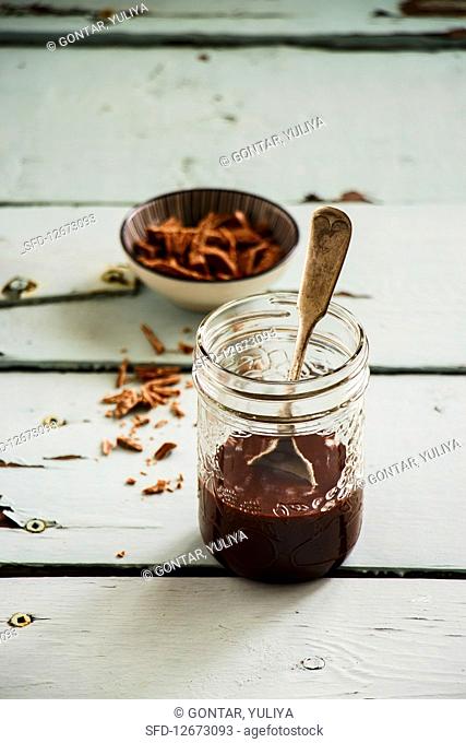 Melted dark chocolate in glass jar