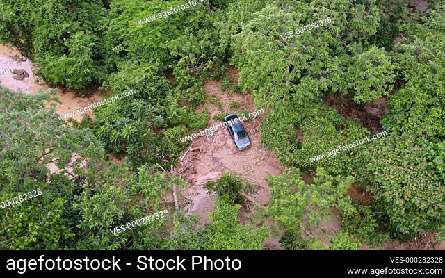 Aerial view a car is trap in mud after severe flash flood