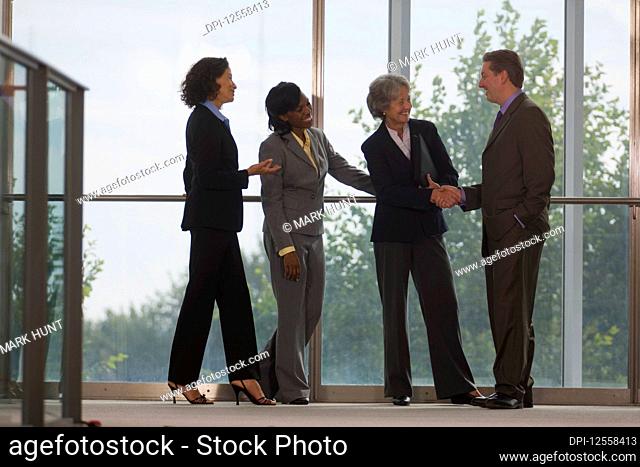 Team of business people standing and shaking hands