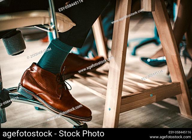 Well Dressed Businessman At Meeting In Office, Close Up Of Men's Legs In Elegant Luxury Leather Shoes, Toned Image