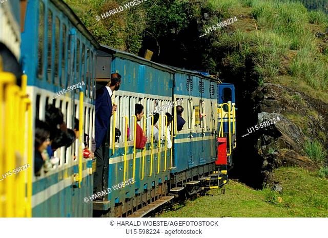 Passengers looking out of the train windows of the Nilgiri Mountain Railway before entering a tunnel during a trip from Ooty to Coonoor