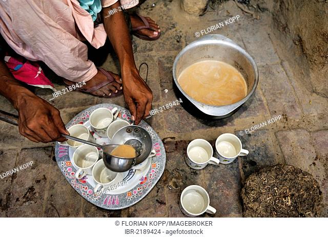 Woman serving traditional black tea with milk, Chai, Lahore, Punjab, Pakistan, Asia