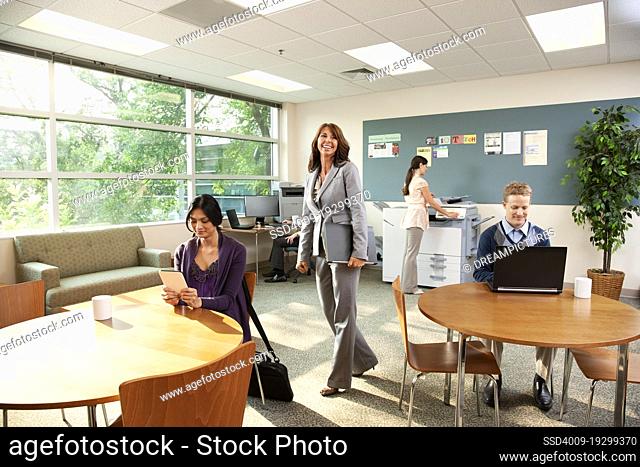 Group of people relaxing while working in an office