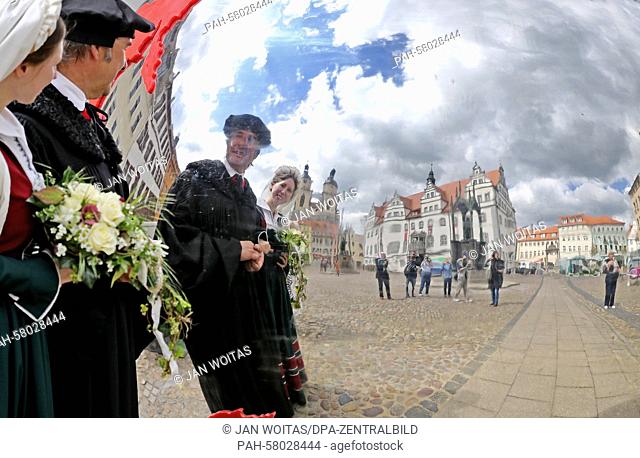 This year's Luther couple Maria Jana Palaschevsky as Katharina von Bora and Fred Goede as Martin Luther are mirrored in a reflecting globe in front of the town...