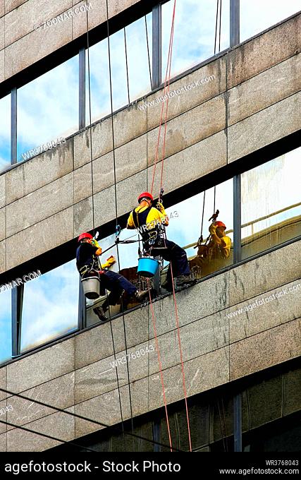 Two window cleaners at risky and danger work