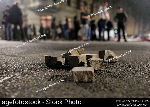 26 September 2023, Saxony, Leipzig: Torn out cobblestones lie on a street. Riots broke out during a left-wing protest against the eviction of a squatted house