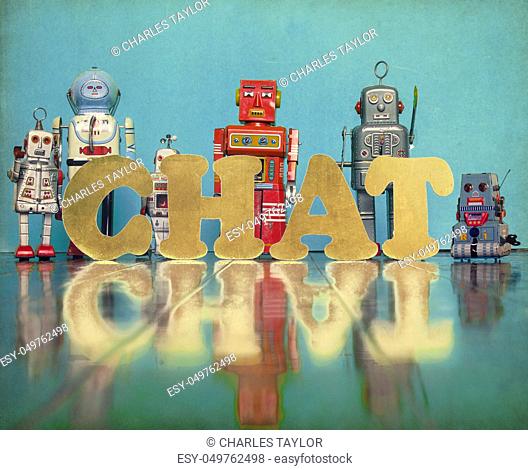 vintage robot toys with the word CHAT on an old fooden floor