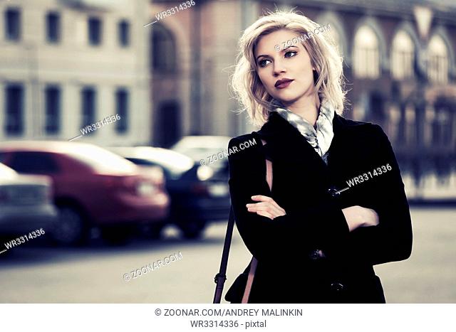 Young fashion woman on the city street